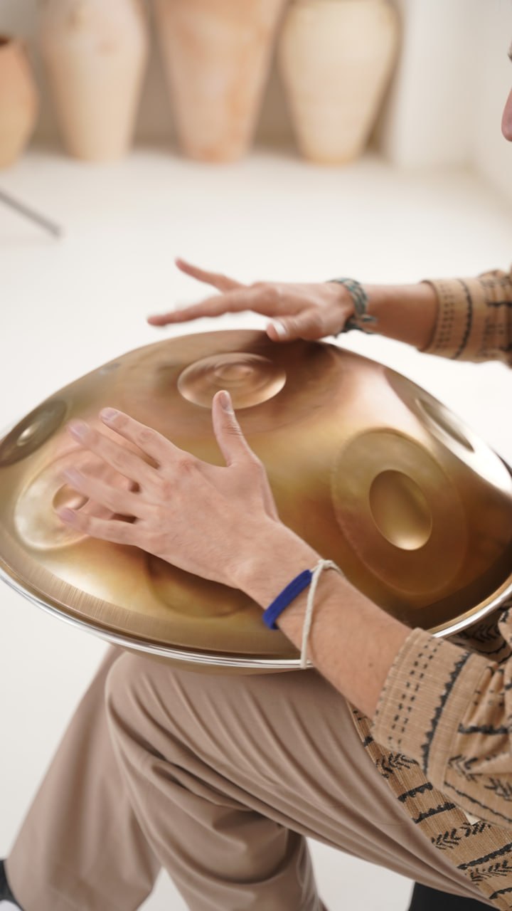 Hands playing handpan